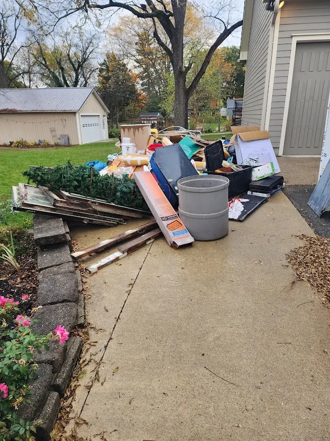 Dumpster being loaded with debris for Roofing Dumpster Rental in Porters Neck
